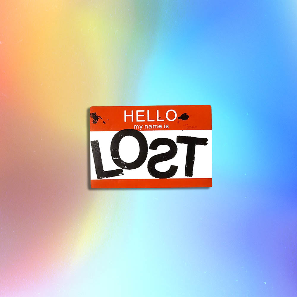 Hello my name is LOST sticker. A red and white nametag sticker stamped with the name LOST with a backwards S. The sticker is set against a holographic background.
