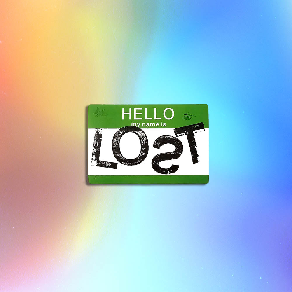 Hello my name is LOST sticker. A green and white nametag sticker stamped with the name LOST with a backwards S. The sticker is set against a holographic background.