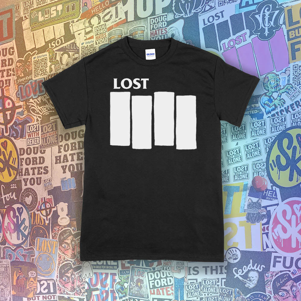 The Lost Flag t-shirt. The iconic bold logo is screen printed in white ink on a black cotton shirt. A collection of colorful graffiti stickers from artists around the world decorate the background.