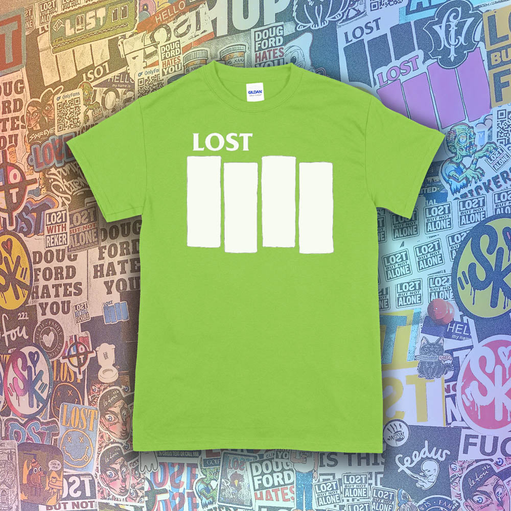 The Lost Flag t-shirt. The iconic bold logo is screen printed in white ink on a lime green cotton shirt. A collection of colorful graffiti stickers from artists around the world decorate the background.