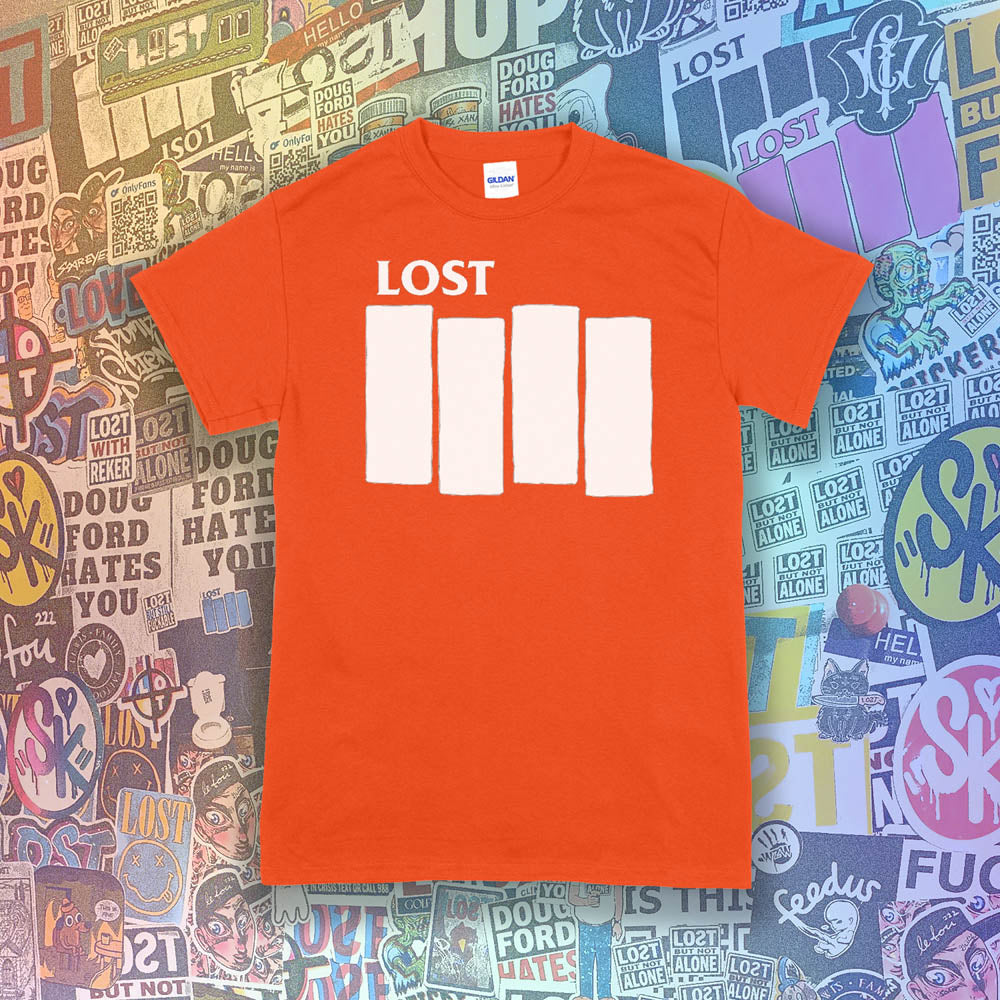 The Lost Flag t-shirt. The iconic bold logo is screen printed in white ink on an orange cotton shirt. A collection of colorful graffiti stickers from artists around the world decorate the background.