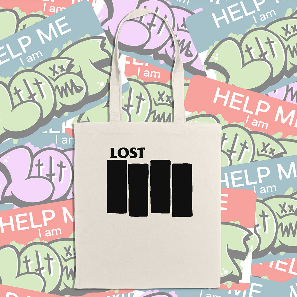 The Lost Flag tote bag. Four Solid black bars  and the word LOST printed across a large, natural canvas tote bag. An assortment of colorful graffiti stickers makes up the display background. 