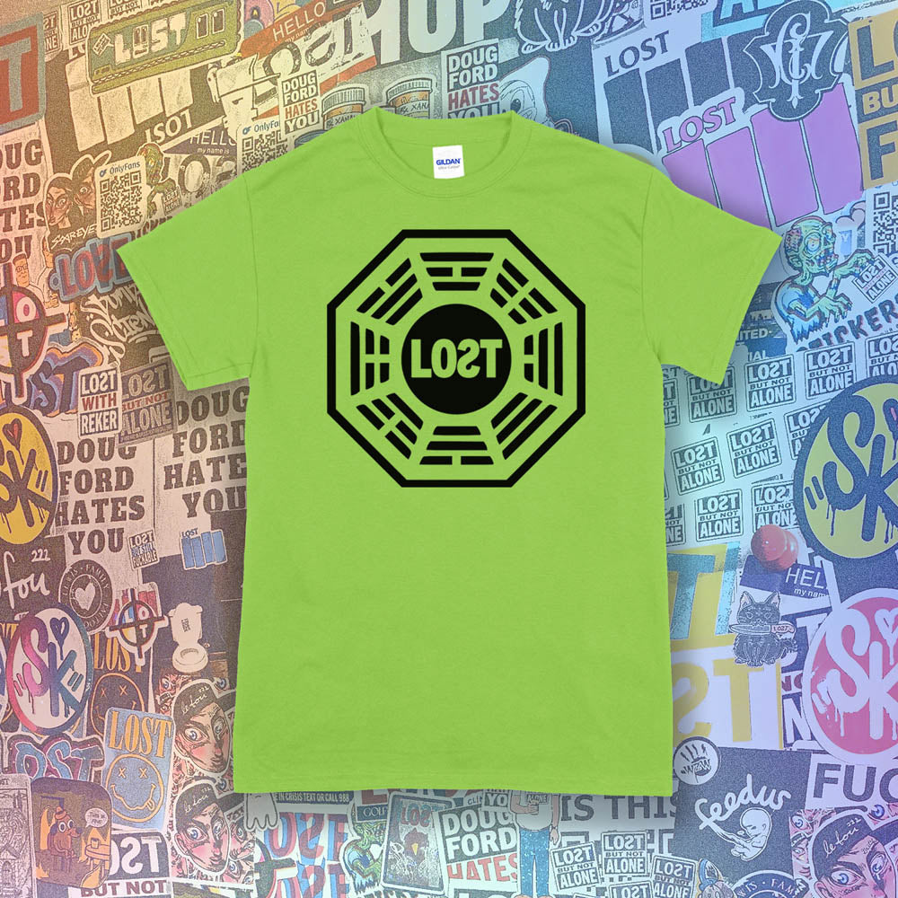 The Lost Initiative t-shirt by Lost Streetwear. The bold black logo is screen printed on a lime green shirt. A wall of brightly colored graffiti stickers from artists around the world provides a background for the shirt.