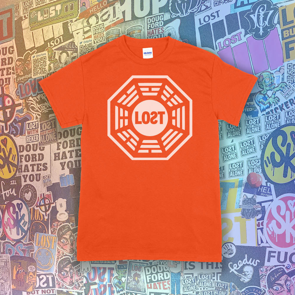 The Lost Initiative t-shirt with a large solid white logo screen printed on an orange shirt. A collection of colorful graffiti stickers from artists all over the world make up the background.