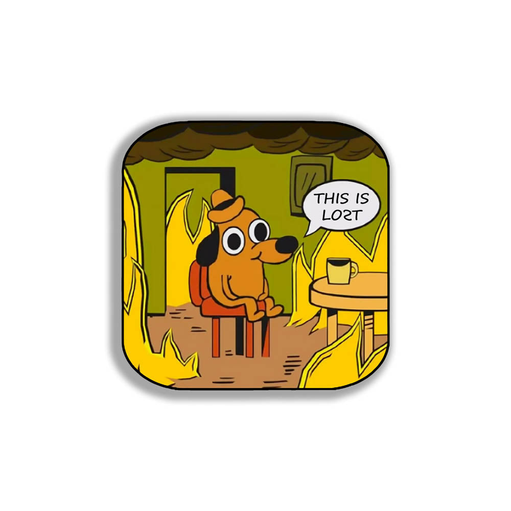The flaming hot "This Is Fine" internet meme modified to say "THIS IS LOST". The image of a cartoon dog calmly sitting at a table with his coffee while the room burns around him is an accurate portrayal of modern day society. This sticker is set against a solid white background.