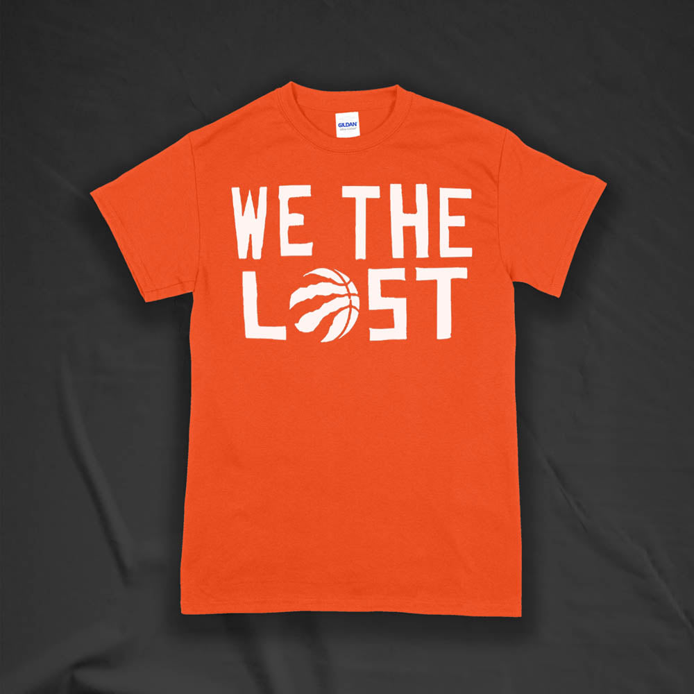 The We The Lost t-shirt. Bold white lettering and raptor claw design screen printed onto a bright orange colored shirt.