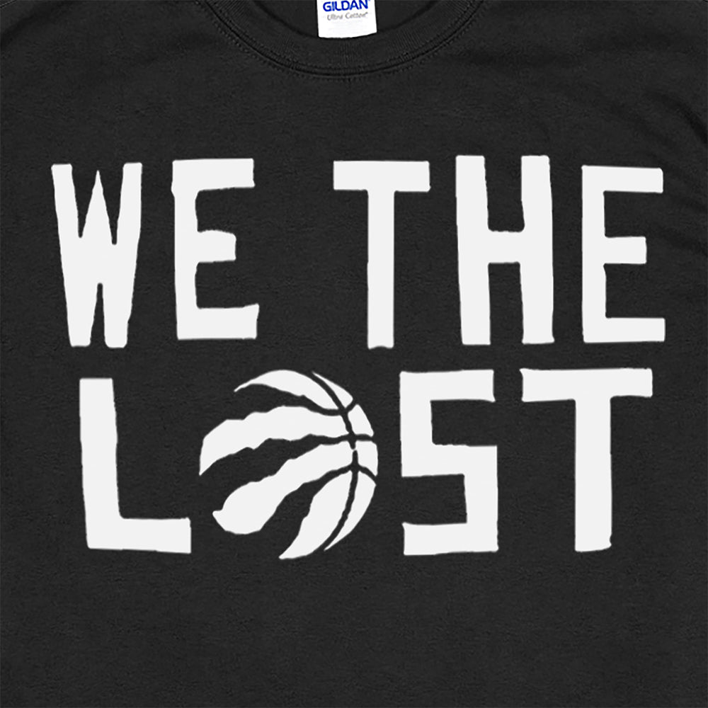 A close up view of the We The Lost t-shirt. Bold white lettering and raptor claw design screen printed onto a black colored shirt.