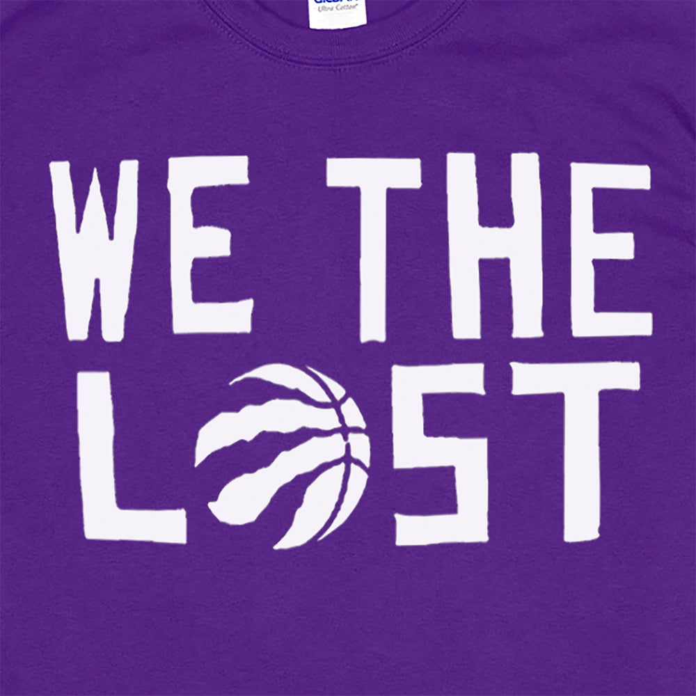close up view of the We The Lost t-shirt. Bold white lettering and raptor claw design screen printed onto a purple colored shirt.