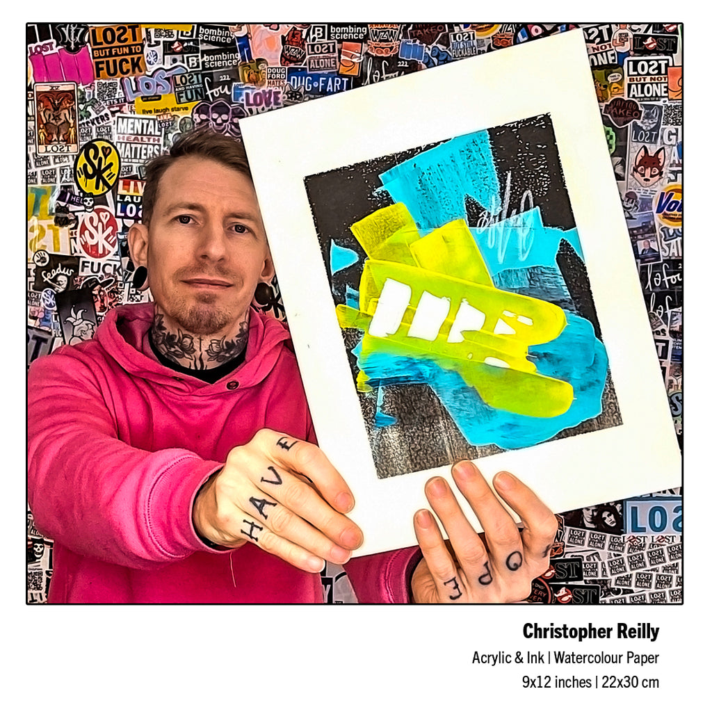 Canadian abstract fine artist Christopher Reilly holding up his completed original 9x12 mixed-media artwork, Painting 243, revealing the true visual scale, saturated yellow hues, and distinctive background ink textures.
