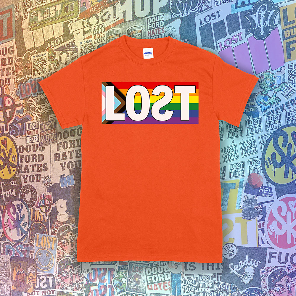 LOST progress flag shirt design by Lost Streetwear. Full color design displayed on an orange shirt. Graffiti stickers from various artists in the background.